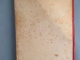 an old book sitting on a table next to a box