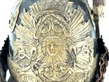 a helmet that has a gold decoration on it