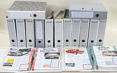 several binders are stacked on top of each other on a table