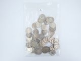 a bag full of silver coins on a white surface