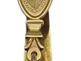 a gold bell with a cross on it on a white background