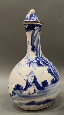 a blue and white vase with a bird on it