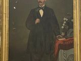 portrait of a man in a tuxedo with a vase of flowers on a table