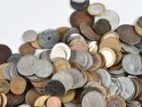 a pile of coins sitting on a white surface