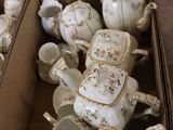 a lot of teapots and cups in a box