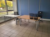 a table and chairs in a room with a large window