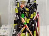 a clear container filled with various types of mascaras