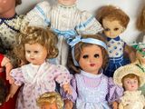 a lot of dolls that are sitting together on a table