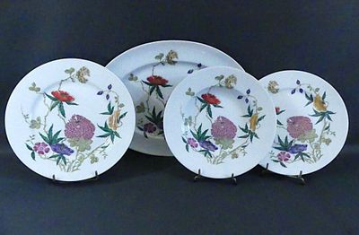 trois assiettes ornées de fleurs sont posées sur une table