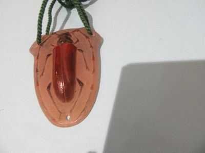 a red object hanging on the wall next to a laptop