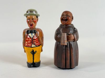 two figurines of a man and a woman standing next to each other