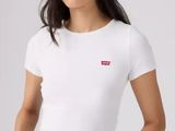 the woman is wearing a white t - shirt and jeans