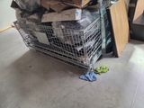 a shopping cart full of boxes and other items in a room