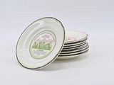 several white plates with black rims are stacked on top of each other