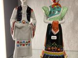 two figurines that are on display in a glass case