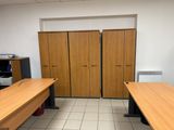 two wooden desks in a room with a tiled floor