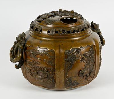 an image of a bronze vase with a dragon on the lid