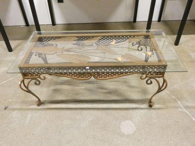 a coffee table with a glass top on a tile floor