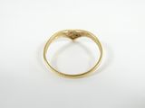 a close up of a gold ring on a white surface