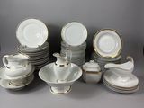 a lot of plates and cups and saucers on the table