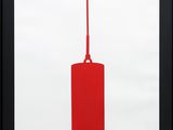 a framed picture of a red canister with a red handle