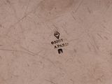 a close up of the bottom of a bowl with a logo on it