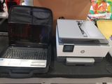 two laptops and a printer sitting on a table