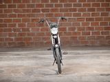 a motorcycle that is parked in front of a brick wall