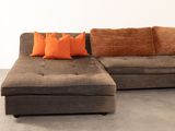 an image of a living room with a couch and pillows
