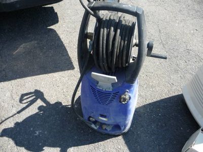 a blue pressurer that is on the ground next to a car