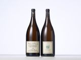 two bottles of wine sitting next to each other on a table