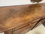 a wooden dresser with a mirror on top of it