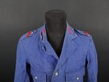 an image of a blue jacket with red buttons on it