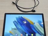 a tablet that is sitting on a table with a cord attached to it