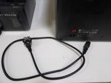 wires connected to a computer monitor on a white surface
