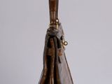 brown leather handbag with handle and strap on a white surface