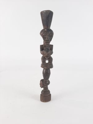 an image of a wooden sculpture of a man with a hat on his head