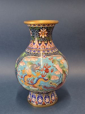 un vase bleu orné d'un dragon, posé sur une table