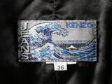 the back of a black jacket with a blue and white wave on it