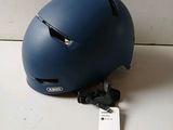 a helmet that is sitting on the floor next to a tag