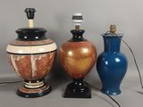 trois vases et une lampe posés sur une table