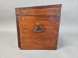 an old wooden box with a metal handle on a white background
