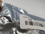a person holding a piece of silver foil with a barcode on it