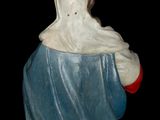 a figurine of a man with a blue robe and a red hat