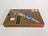 an open box with a sword on top of it sitting on a table