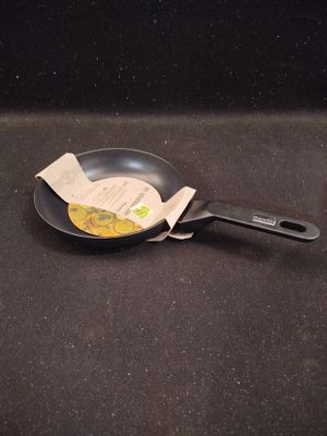 a frying pan with a piece of paper sticking out of it