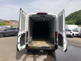 a white van with its doors open in a parking lot