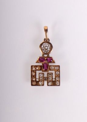 une image représentant un pendentif en diamant et en or sur lequel figure un homme