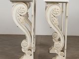 pair of white marble pedestals with carved designs on top of them