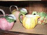 three vases that are sitting on a shelf in a cabinet